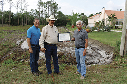 Manager of Operations Michael Dillon, left, and Board President Stephen Hinkle award certificate to landowner Bill Dean.